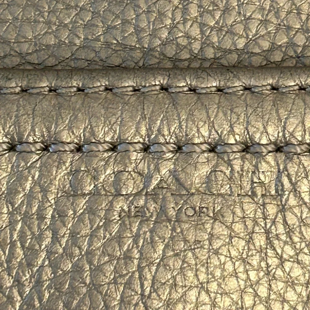 Coach metallic leather wristlet clutch purse.